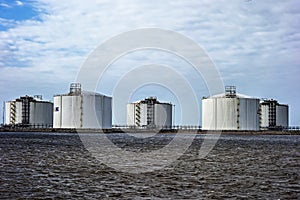 Industria oil storage tanks on the water front photo