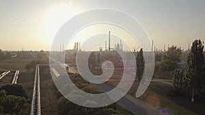 Industrial aerial view of big modern oil and gas plant or factory with sun and lens flare