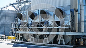 industrial air conditioner. Air conditioner units HVAC on a roof of industrial building with blue sky and clouds in the