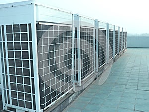 Industrial air conditioner condensers outside unit on the roof of a building
