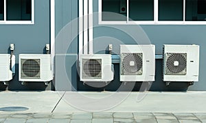 Industrial air conditioner condensers outside unit on the roof of a building on a hot summer day