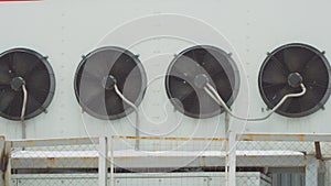 Industrial air conditioning system. Large fans on wall of the building