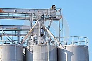 Industrial architecture silo, large tanks made of concrete for storage bulk materials under blue sky