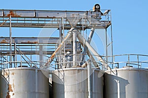 Industrial architecture silo, large tanks made of concrete for storage bulk materials under blue sky