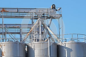 Industrial architecture silo, large tanks made of concrete for storage bulk materials under blue sky