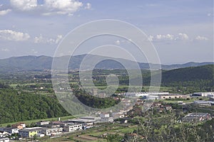 Industrial area among the green hills of Tuscany includes warehouses of artisan firms
