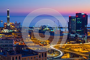 Industrial area near the port with Lanterna and commercial skyscrapers at sunset, Genoa, Italy