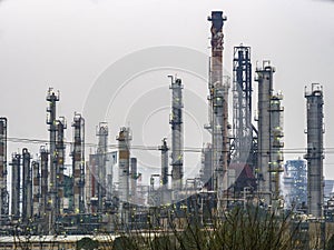 Industrial area refineries amid cloudy skies gray.