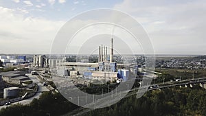 Industrial area and smoking chimney on power plant near the city. landscape. Stock footage. Smoke staks from boiler