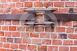 Industrial background fastening cracked wall rusty old fastening for pipes fastened red brick wall