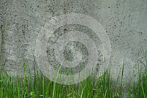 Industrial background. Green grass growing from the bottom of an