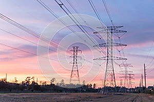 Industrial background group silhouette of transmission towers sunset