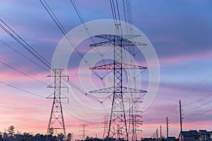 Industrial background group silhouette of transmission towers sunset