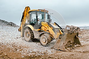 Industrial backhoe excavator machinery on road construction site