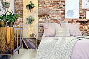 Industrial bedroom with pink bedding