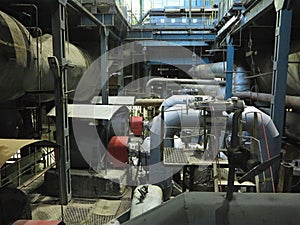 Industrial big water pumps with electric motors, pipes, tubes, equipment and steam turbine at power plant