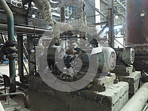 Industrial big water pumps with electric motors, pipes, tubes, equipment and steam turbine at power plant