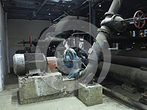 Industrial big water pumps with electric motors, pipes, tubes, equipment and steam turbine at power plant