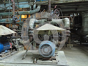 Industrial big water pumps with electric motors, pipes, tubes, equipment and steam turbine at power plant