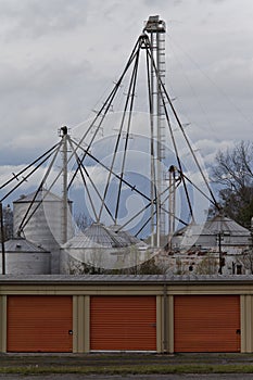 Industrial bins with orange storage sheds. Vertical.