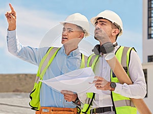 Industrial, blueprint and team of construction workers in the city planning maintenance or repairs on rooftop