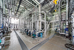 Industrial boiler interior with lots of pipes, pumps and valves