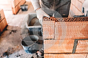 Industrial bricklayer installing bricks on construction site