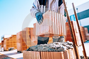 Industrial bricklayer installing bricks on construction site