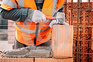 industrial bricklayer installing bricks on construction site