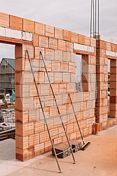 industrial bricklayer installing bricks on construction site