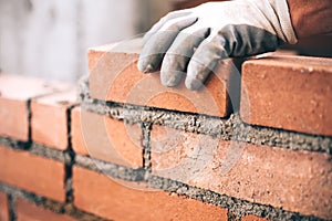 Industrial bricklayer installing bricks on construction site