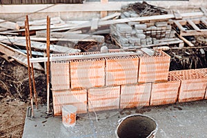 Industrial bricklayer installing bricks on construction site. Details of house building and construction