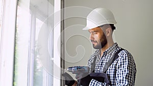 Industrial builder worker at window installation in new home