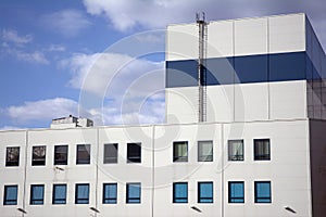 Industrial building against the blue sky. Factory. Modern factory buildings and warehouses.