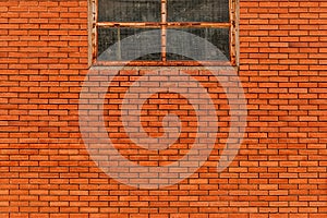 Industrial building brick wall with old metal window as background