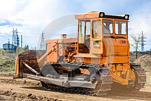 Industrial building construction site bulldozer leveling and moving soil during highway building