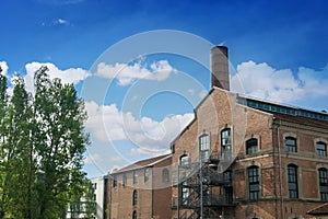 Industrial building with a tower and trees