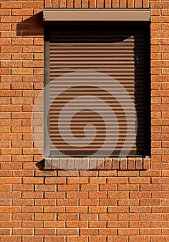 Industrial building window with shutter closed.