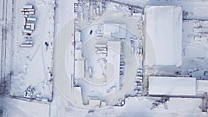 Industrial buildings and hangars. Industrial zone in the city in a snowy winter.