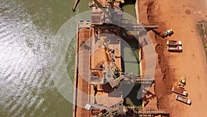 Industrial cargo port with operating cranes on the Danube river