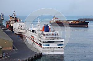 Industrial cargo ships and cruise liner at port photo