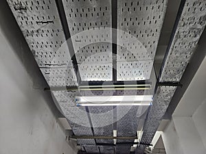 Industrial Ceiling with Cable Trays and Fluorescent Light