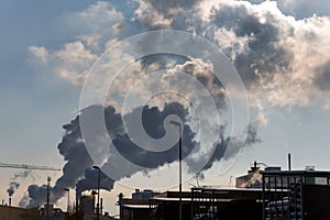 Industrial chimney with exhaust gases photo