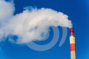 Industrial chimney with exhaust gases photo