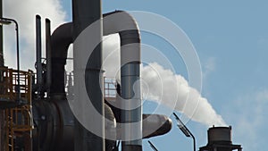 Industrial chimney expelling industrial smoke between pipes