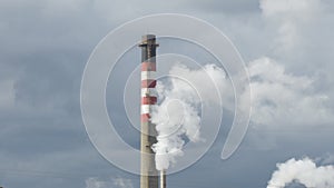 Industrial chimney expelling smoke columns in a industrial factory