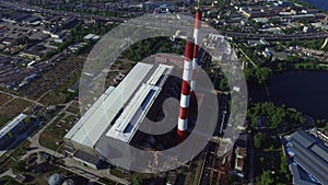 Industrial chimney power plant in modern city. Drone view pipe water power plant