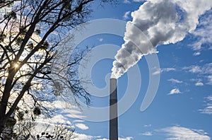 Industrial chimney, thermal power plant, pollution in the air, steam cooling tower in Graz, Styria region, Austria