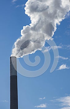 Industrial chimney, thermal power plant, pollution in the air, steam cooling tower in Graz, Styria region, Austria