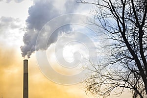 Industrial chimney, thermal power plant, pollution in the air, steam cooling tower in Graz, Styria region, Austria, at sunset